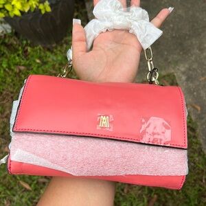 Small salmon color clutch bag with gold accents